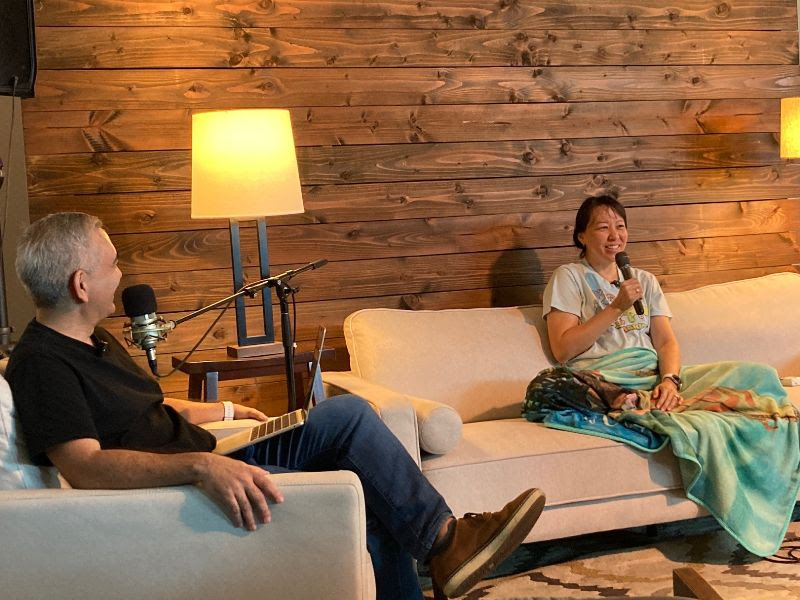 Anne sits down on the couch with Pastor Dave