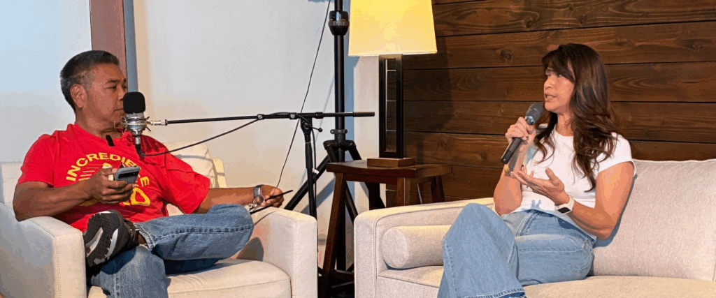 Colleen sits down on the couch with Neil