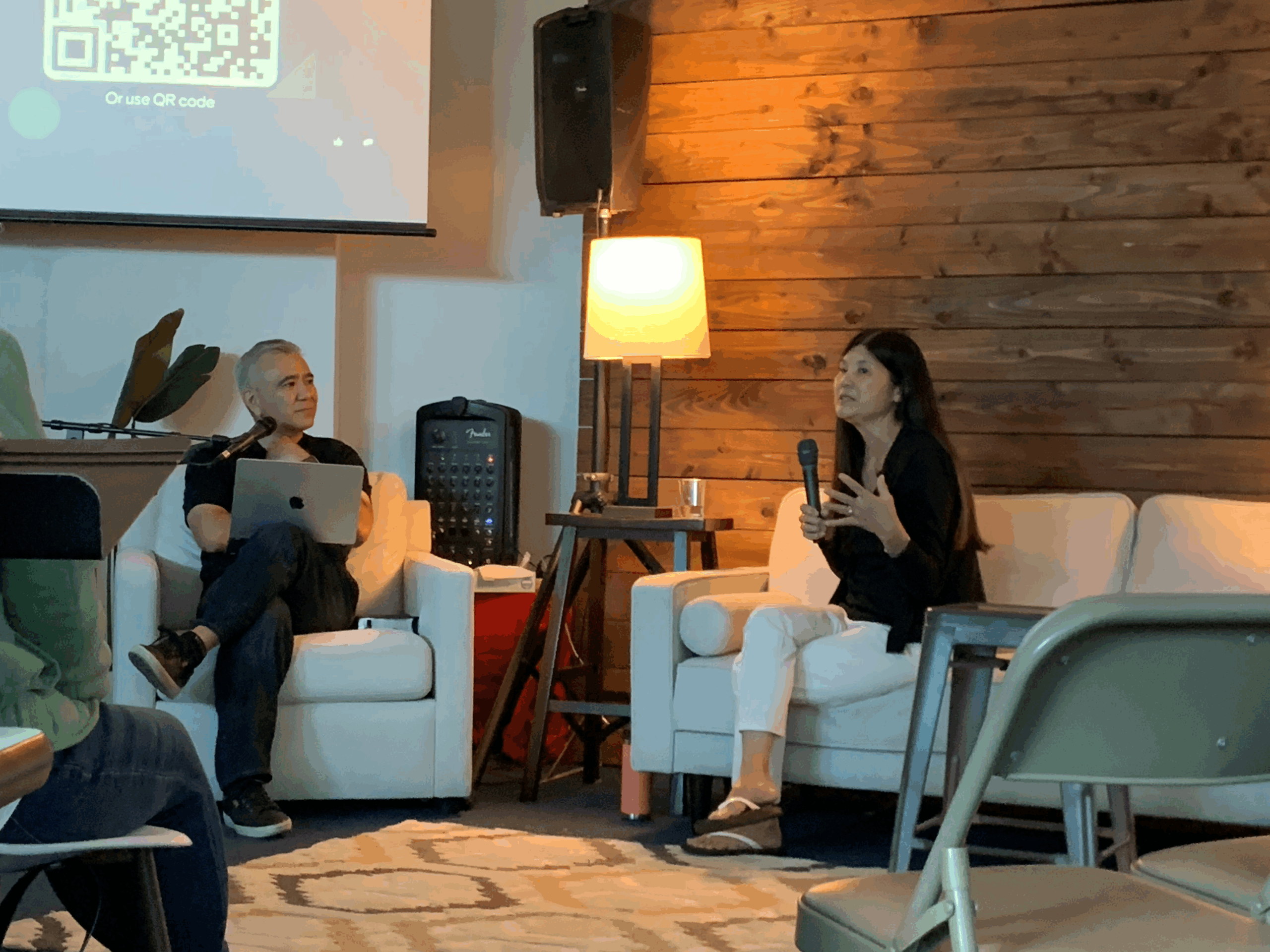 Corinne sits down on the couch with Pastor Dave