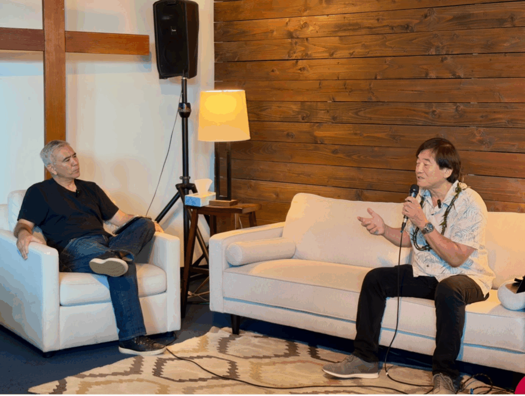 Daniel sits down on the couch with Pastor Dave