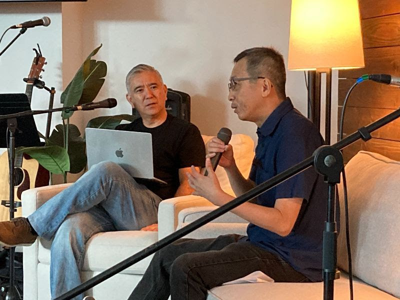 Danny sits down on the couch with Pastor Dave