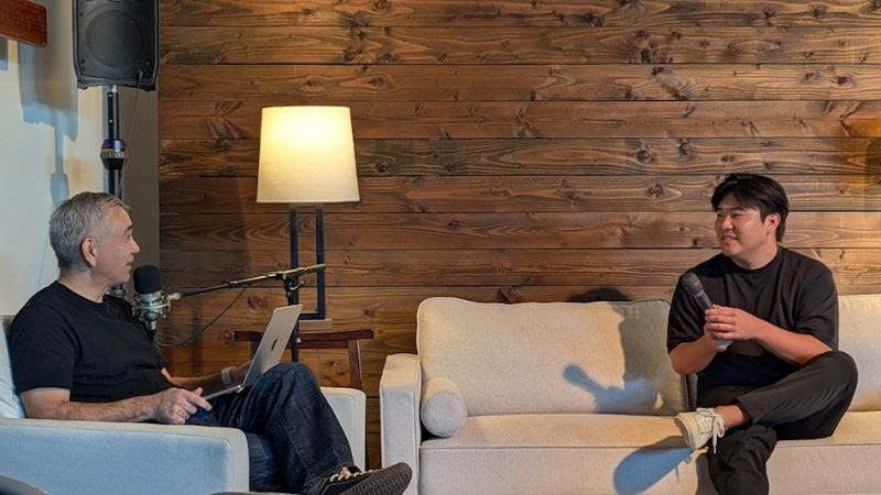 Hunter sits down on the couch with Pastor Dave