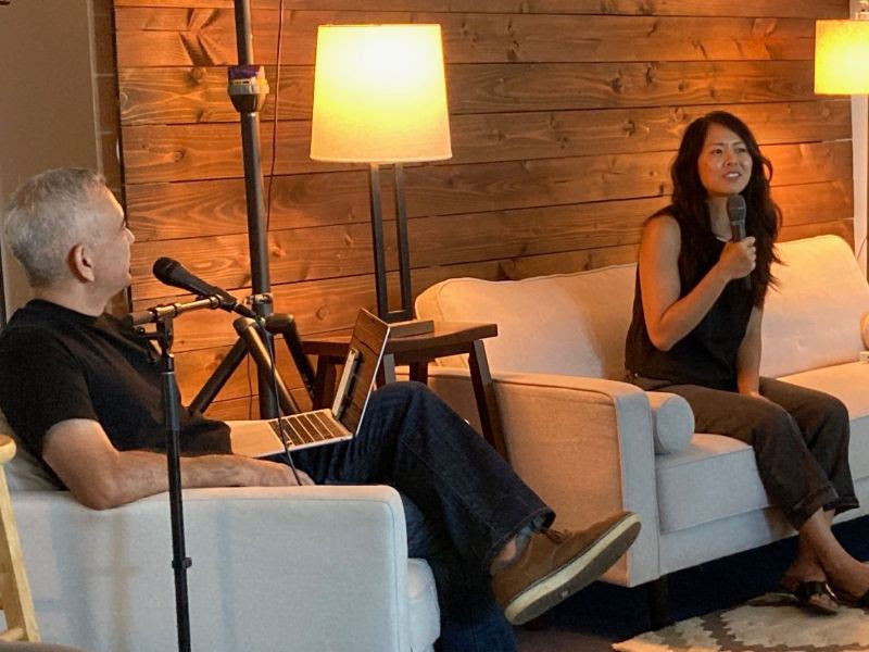 Joanna sits down on the couch with Pastor Dave