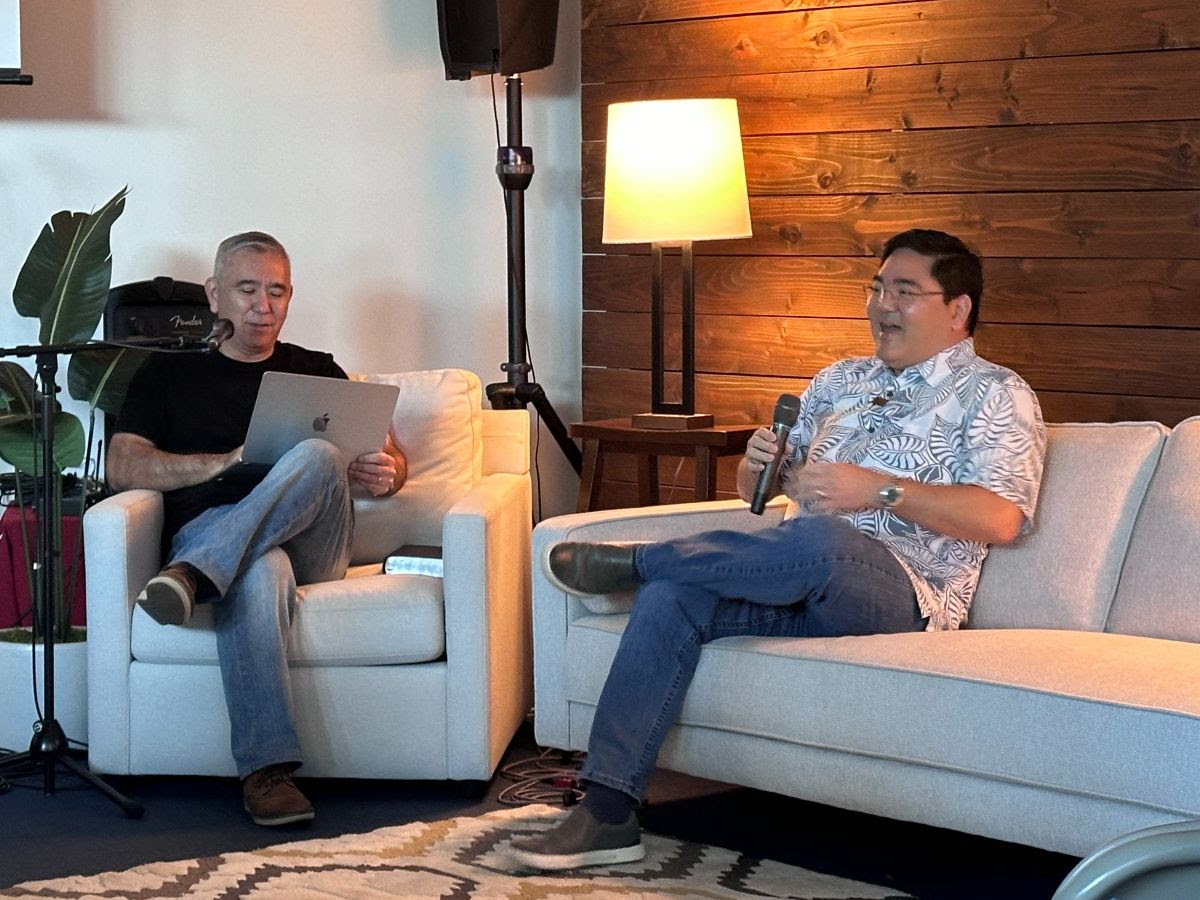 Michael sits down on the couch with Pastor Dave