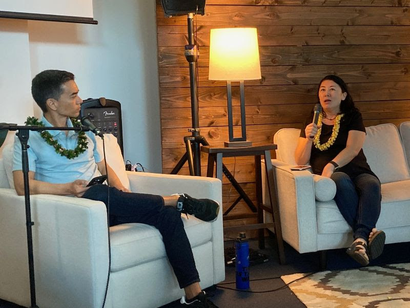 Mina sits down on the couch with Chris