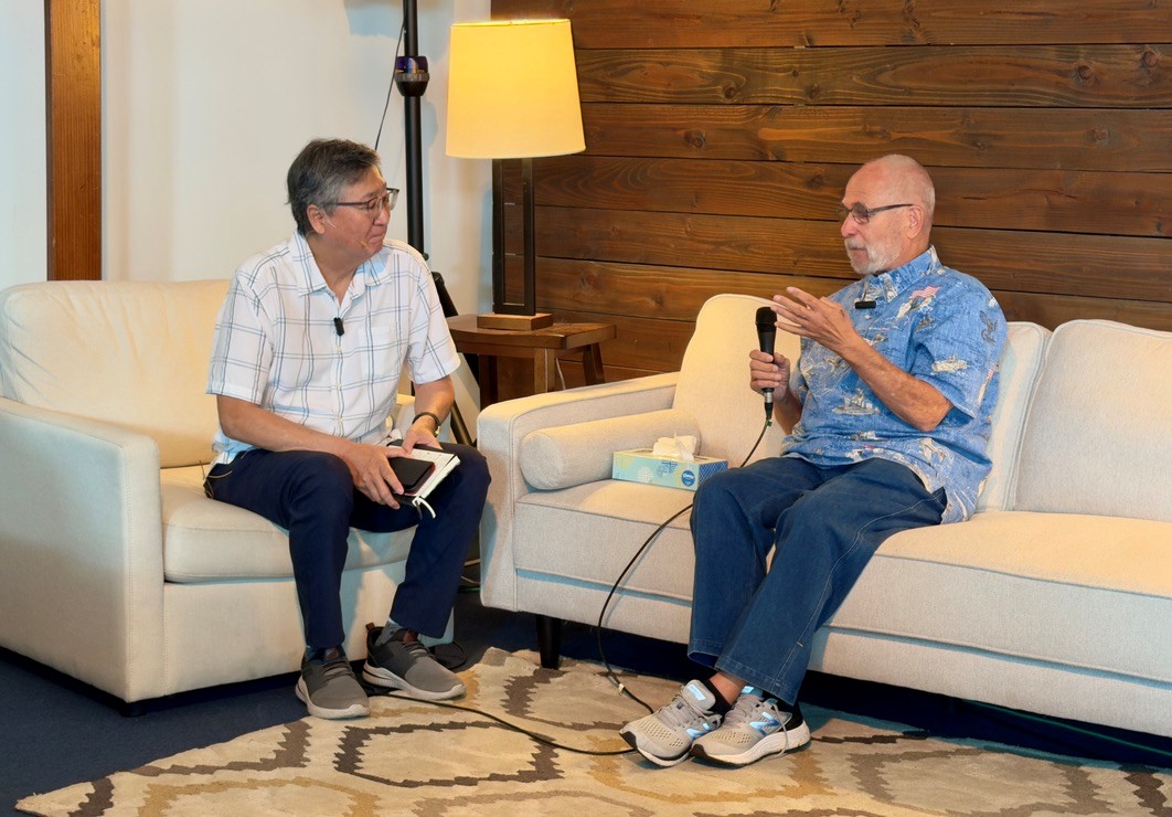Ray sits down on the couch with Pastor Mark